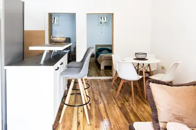 a kitchen and living room with a table and chairs at Green Garden in Tivat