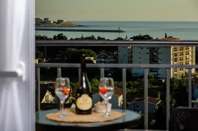 a table with two glasses and a bottle of wine at Alpha Mare in Bar