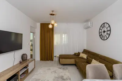 a living room with a couch and a flat screen tv at Alpha Mare in Bar