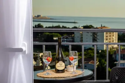 a table with two glasses and a bottle of wine at Alpha Mare in Bar