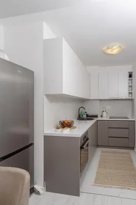 a kitchen with white cabinets and a bowl of fruit on the counter at Alpha Mare in Bar