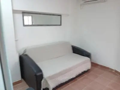a small bench in a room with a window at Mota saste mini duplex in Sveti Stefan