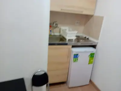 a small kitchen with a sink and a refrigerator at Mota saste mini duplex in Sveti Stefan