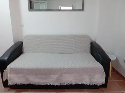 a small bed in a room with at Mota saste mini duplex in Sveti Stefan