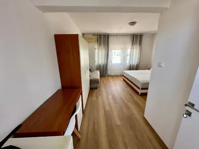 a small room with a bedroom and a bed at Villa Paris in Donji Štoj