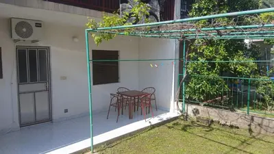 a patio with two chairs and a table on it at Apartman Lastva in Lastva