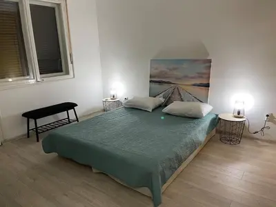 a bedroom with a large bed with two pillows at Apartment Mijuskovic in Kravlja