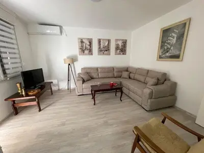 a living room with a couch and a table at Apartment Mijuskovic in Kravlja