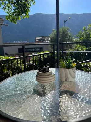 a glass table with a vase sitting on top of it at Apartment Mijuskovic in Kravlja