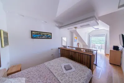 a bedroom with a bed in a room at Apartmani Elena in Bigovo