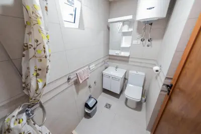 a small bathroom with a toilet and a sink at Apartmani Elena in Bigovo