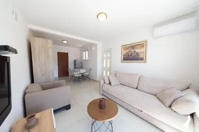 a living room with a couch and a table at Apartmani Elena in Bigovo