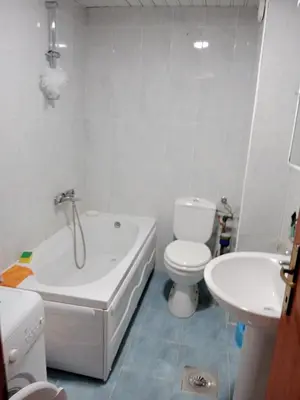 a bathroom with a tub and a toilet and a sink at Apartman centar Bar in Svijetin Brijeg