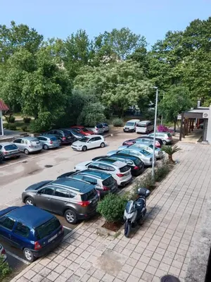 a parking lot with a bunch of parked cars at Apartman centar Bar in Svijetin Brijeg