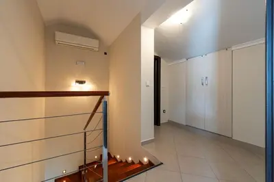 a hallway of a house with a staircase and a door at Vista Apartment in Kotor