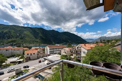 a view of a city with mountains in the background at Vista Apartment in Kotor