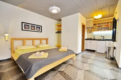 a bedroom with a bed with flip flops on it at Apartments Spasoje 1 in Dobrota