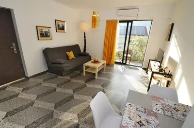 a living room with a couch and a table at Apartments Spasoje 1 in Dobrota