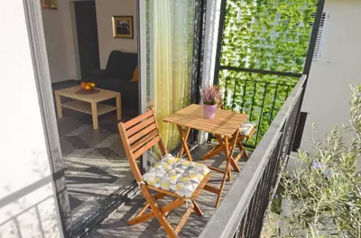 a balcony with a table and chairs on a balcony at Apartments Spasoje 1 in Dobrota