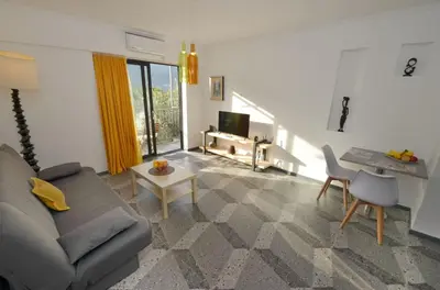 a living room with a couch and a table at Apartments Spasoje 1 in Dobrota