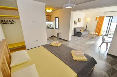 a room with a bed and a living room at Apartments Spasoje 1 in Dobrota