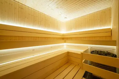 a sauna with wood paneling and a ceiling at Bellemond Hotel & Residences in Budva