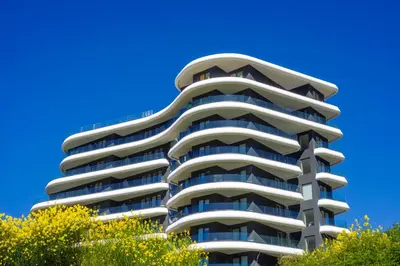 a tall apartment building against a blue sky at Bellemond Hotel & Residences in Budva