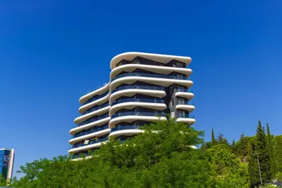 a tall apartment building on top of a tree at Bellemond Hotel & Residences in Budva