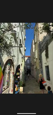 a woman standing in an alley between two buildings at Citadela Old Town Budva in Budva