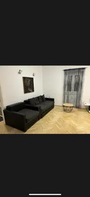 a living room with two black couches in a room at Citadela Old Town Budva in Budva
