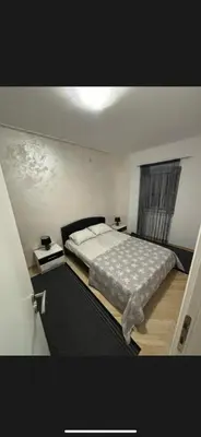 a bedroom with a large bed and a window at Citadela Old Town Budva in Budva