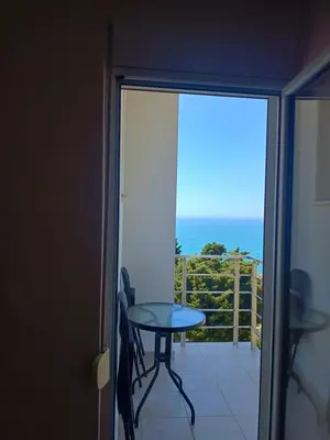 a balcony with a table and a view of the ocean at Jasmin 1 in Ulcinj