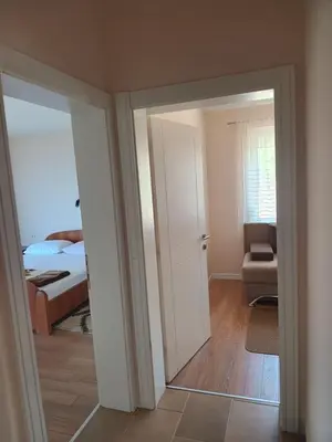 a room with a door open to a bedroom with a bed at Jasmin 1 in Ulcinj