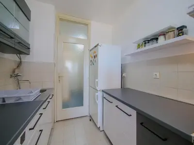 a kitchen with a white refrigerator and a sink at Apartman Baranka in Bar