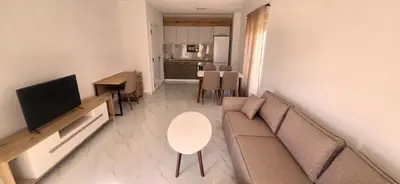a living room with a couch and a table at Kosara apartman Velika Plaža Ulcinj in Ulcinj