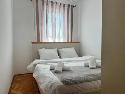 a bedroom with a bed with two pillows on it at Alpha Centrum in Bar