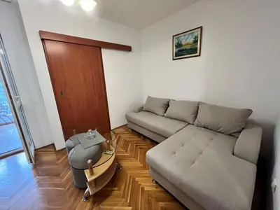 a living room with a couch and a table at Alpha Centrum in Bar