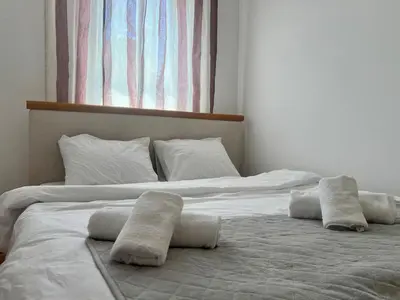 a large white bed with two pillows on it at Alpha Centrum in Bar