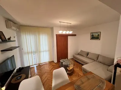 a living room with a couch and a table at Alpha Centrum in Bar