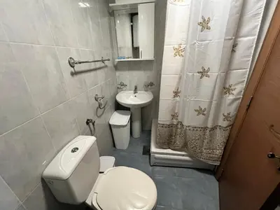 a white bathroom with a toilet and a sink at Alpha Centrum in Bar