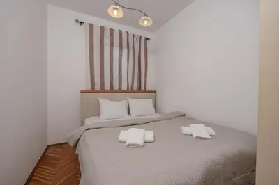 a bedroom with a bed with two towels on it at Alpha Centrum in Bar