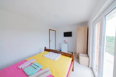 a bedroom with a bed and a large window at King`s Heaven Apartments in Budva