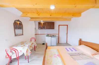 a room with two beds and a kitchen at King`s Heaven Apartments in Budva