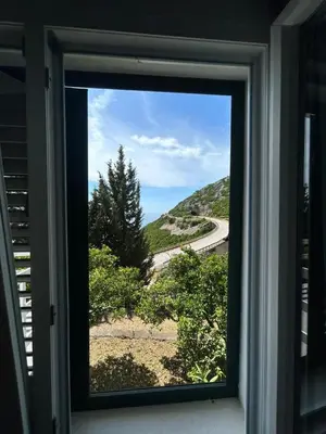 a window with a view of a road at Prestige House in Dobra Voda