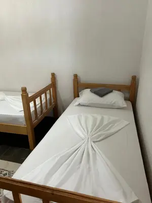 two twin beds in a room with at Prestige House in Dobra Voda
