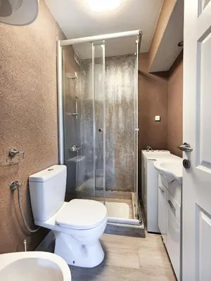 a bathroom with a toilet and a shower and sink at Central comfy apartment in Budva