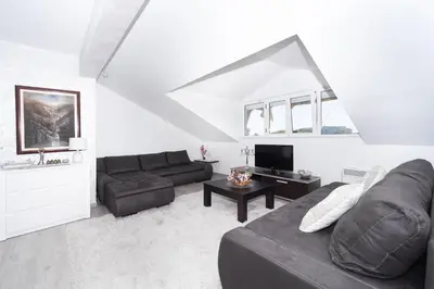 a living room with a couch and a table at Central comfy apartment in Budva
