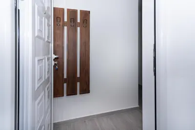an open door with three doors in a room at Central comfy apartment in Budva