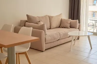 a living room with a couch and a table at Summer Apartment with pool in Petrovac na Moru