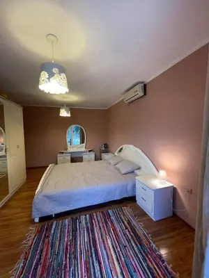 a bedroom with a large bed and a rug at Olive Hill Home in Becici
